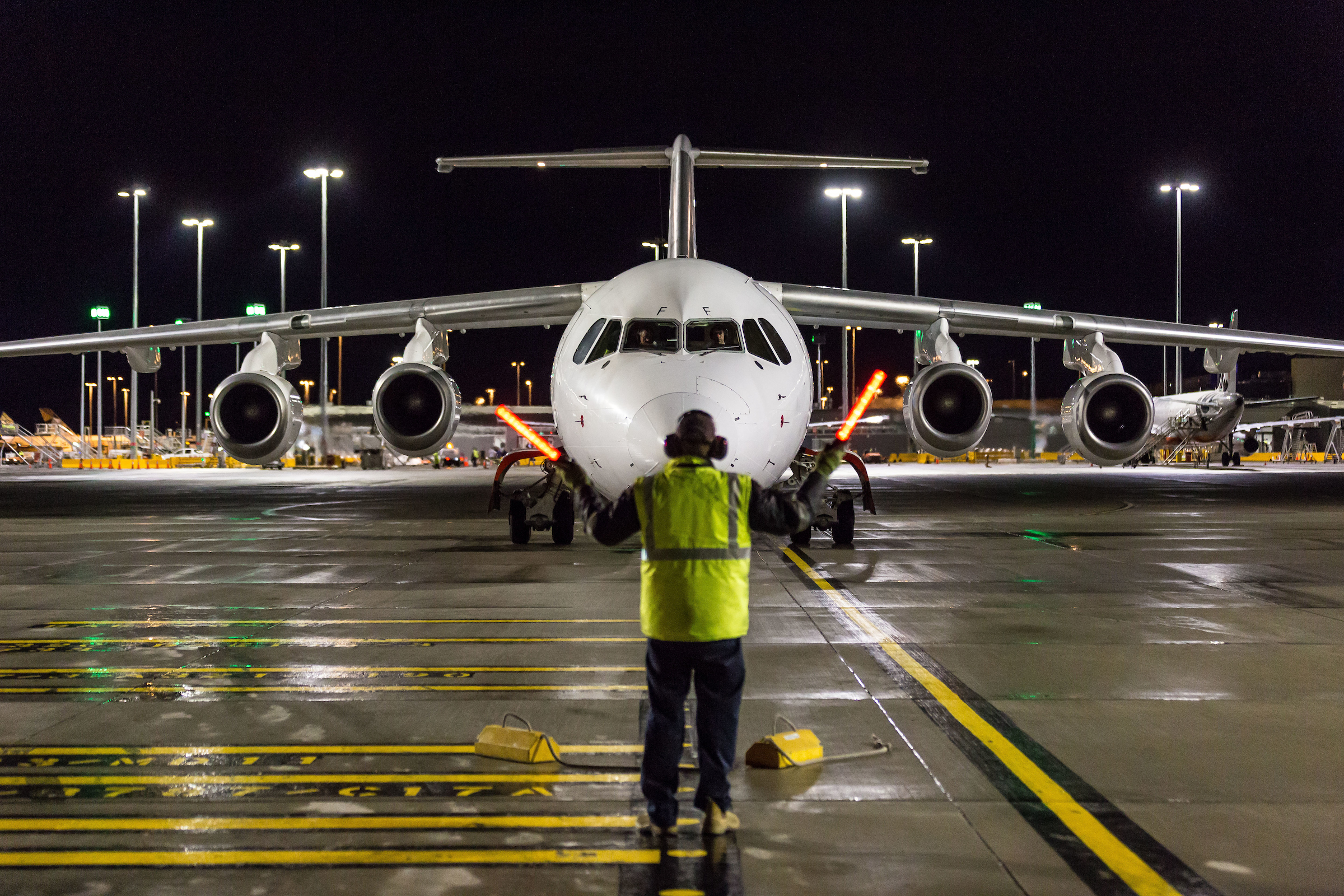 Aircraft on tarmac with worker