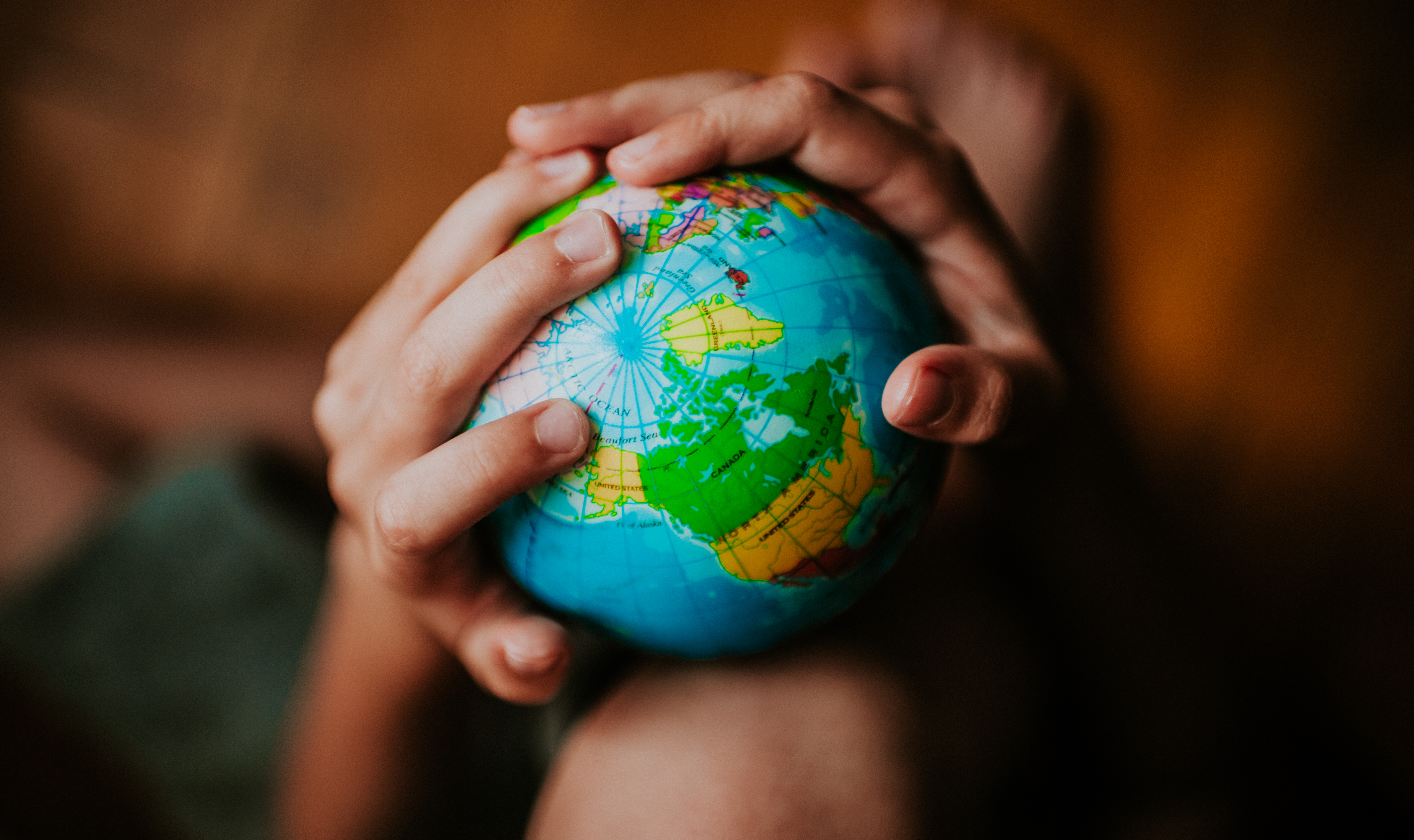 Person holding a globe