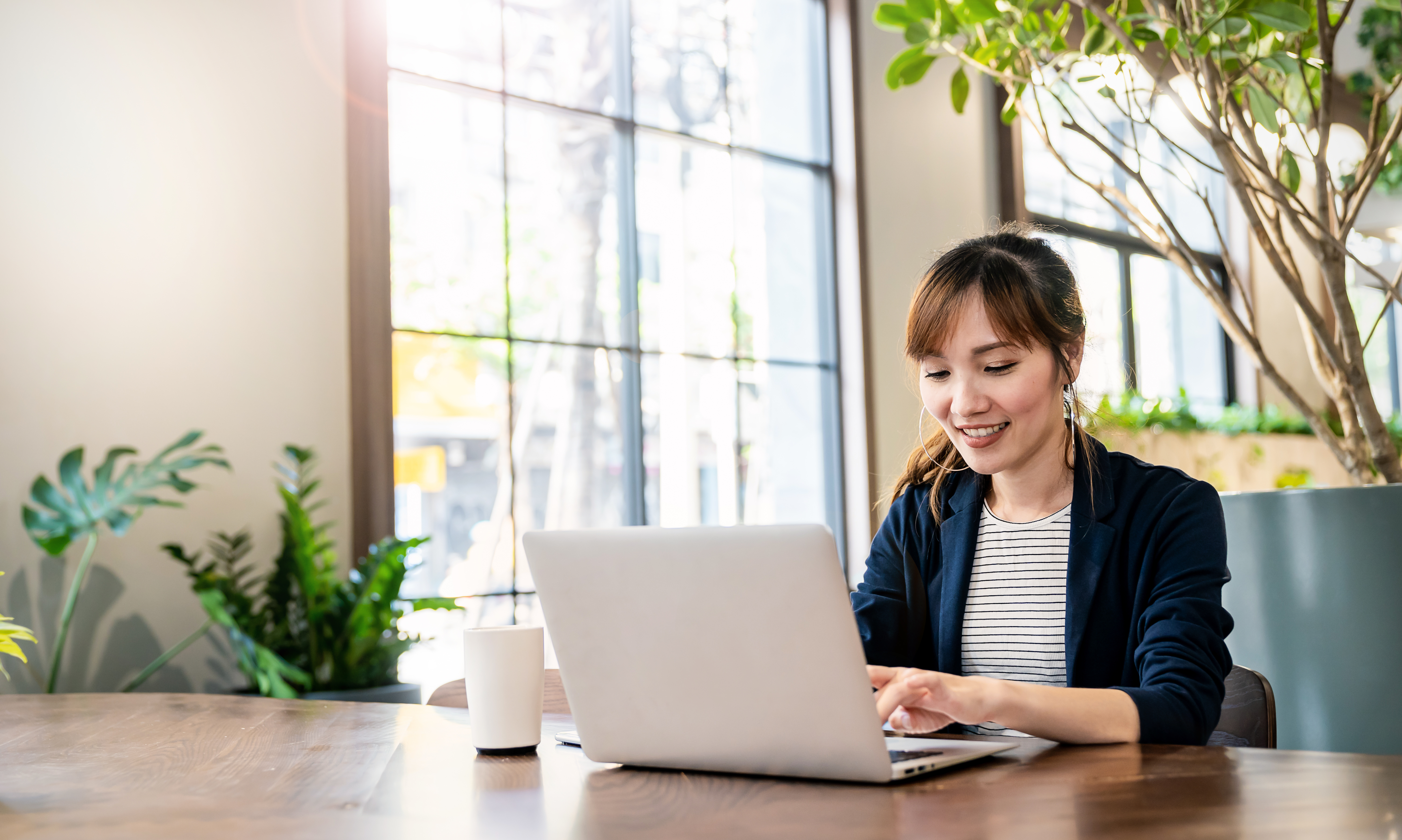 Woman in office using laptop