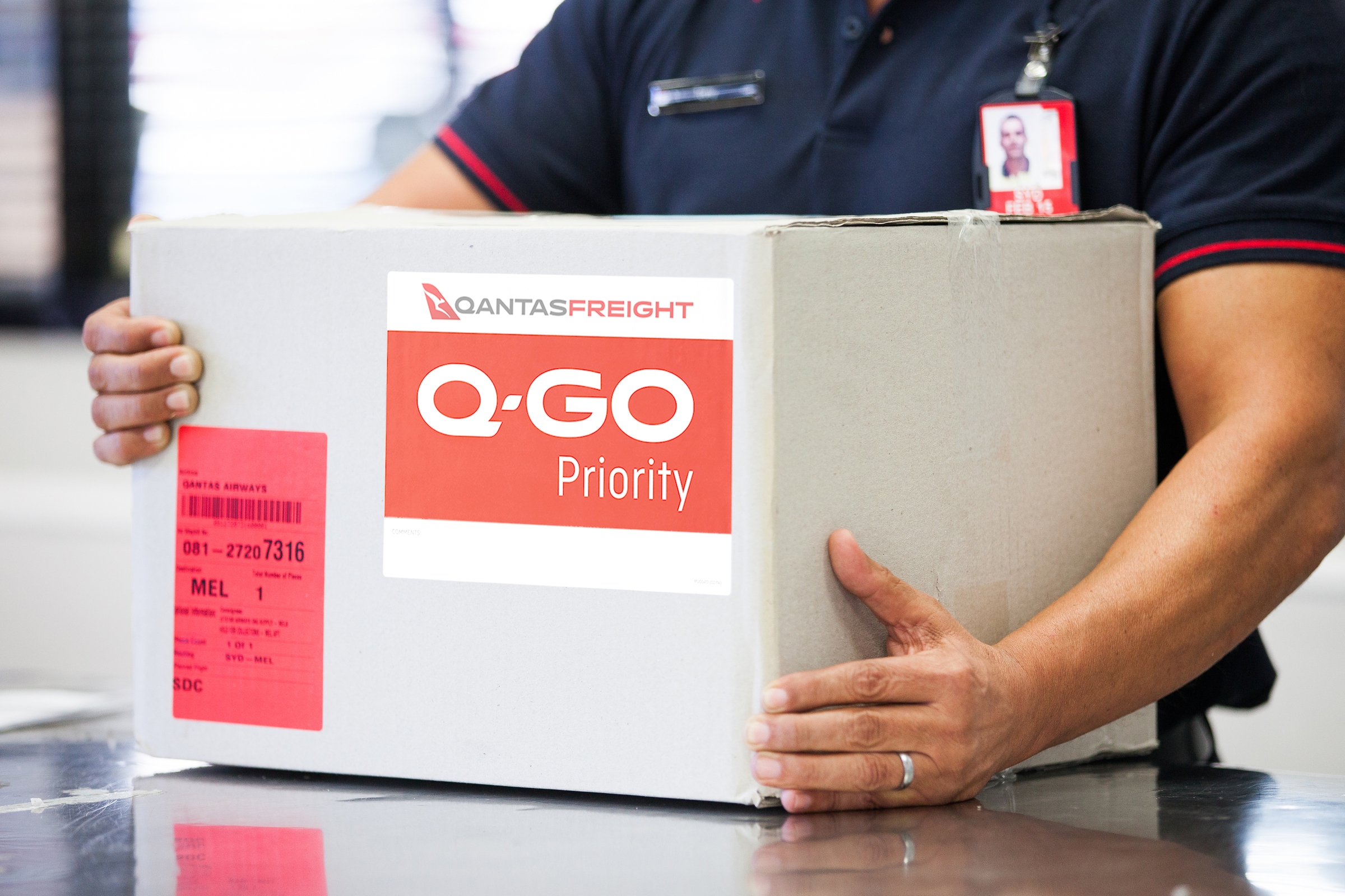 Person holding Q-Go Priority box