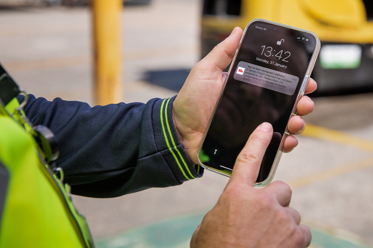 Driver holding phone showing Dock Direct notification