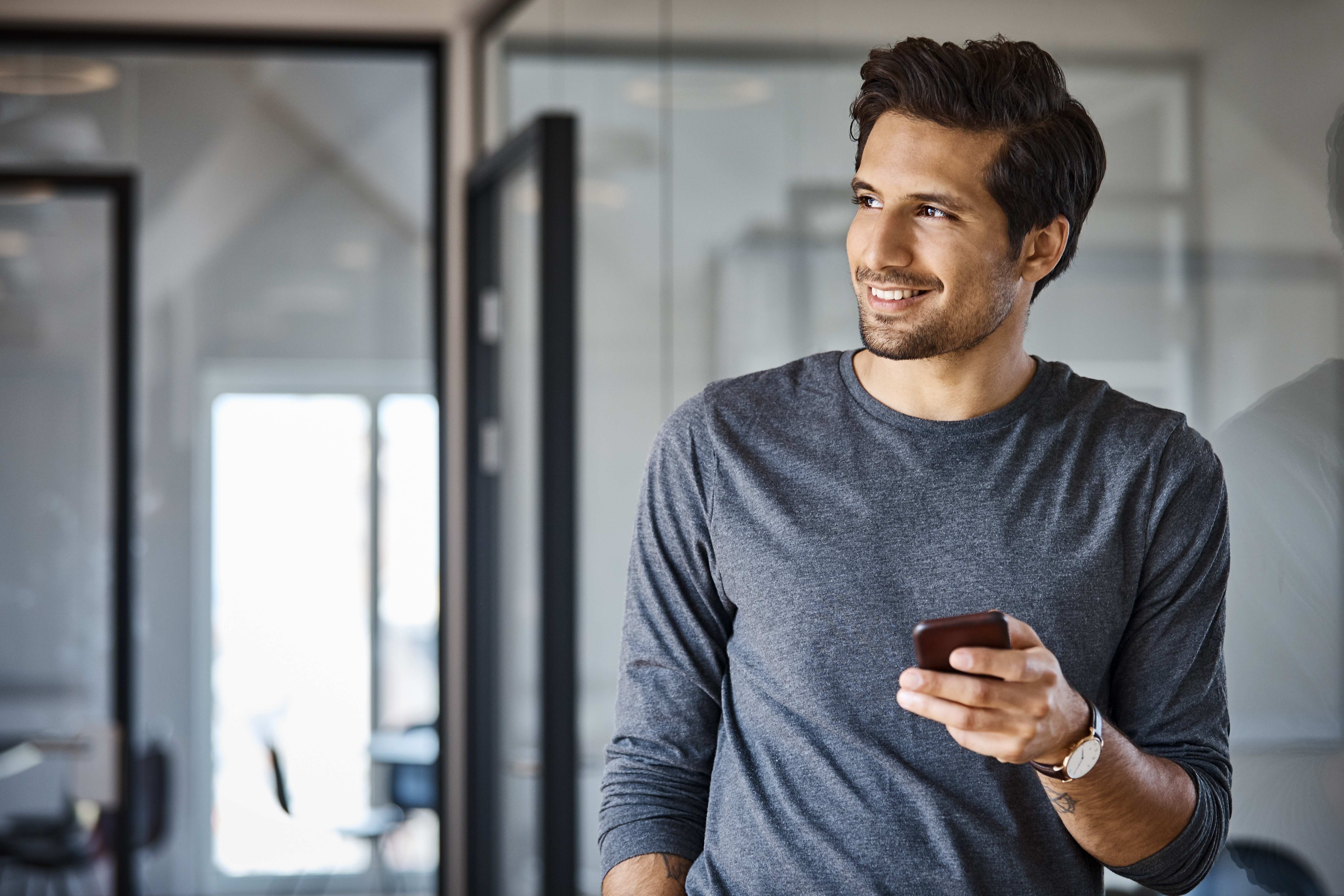 Smiling business man with phone in hand