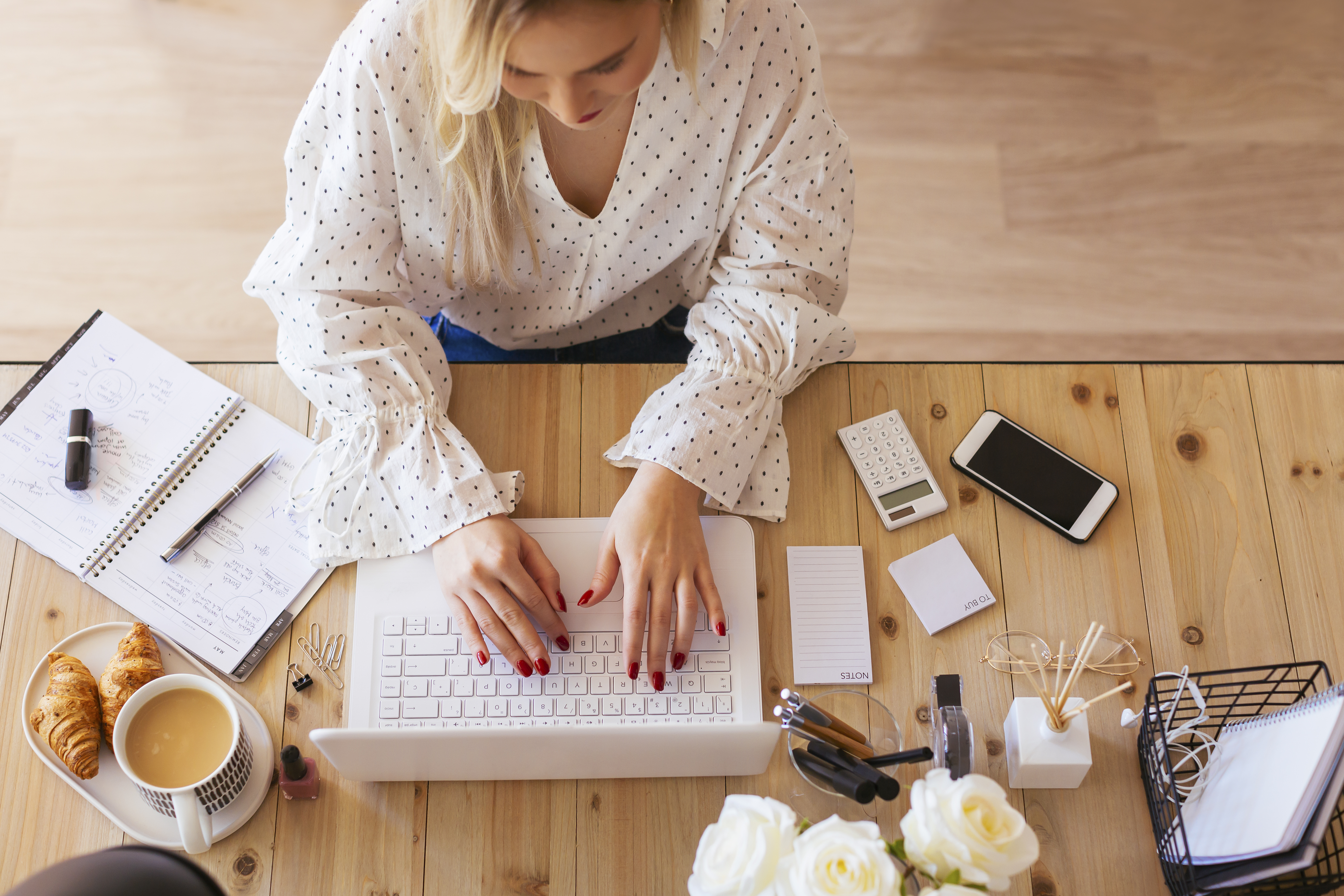 Young woman sitting at desk with laptop