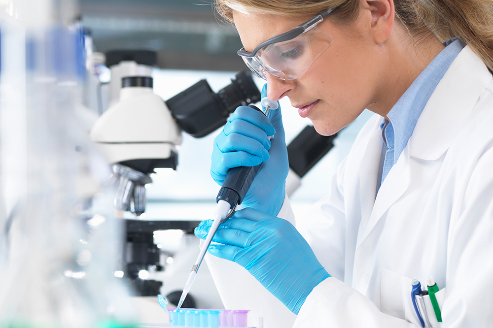 Woman packing box of pharmaceuticals